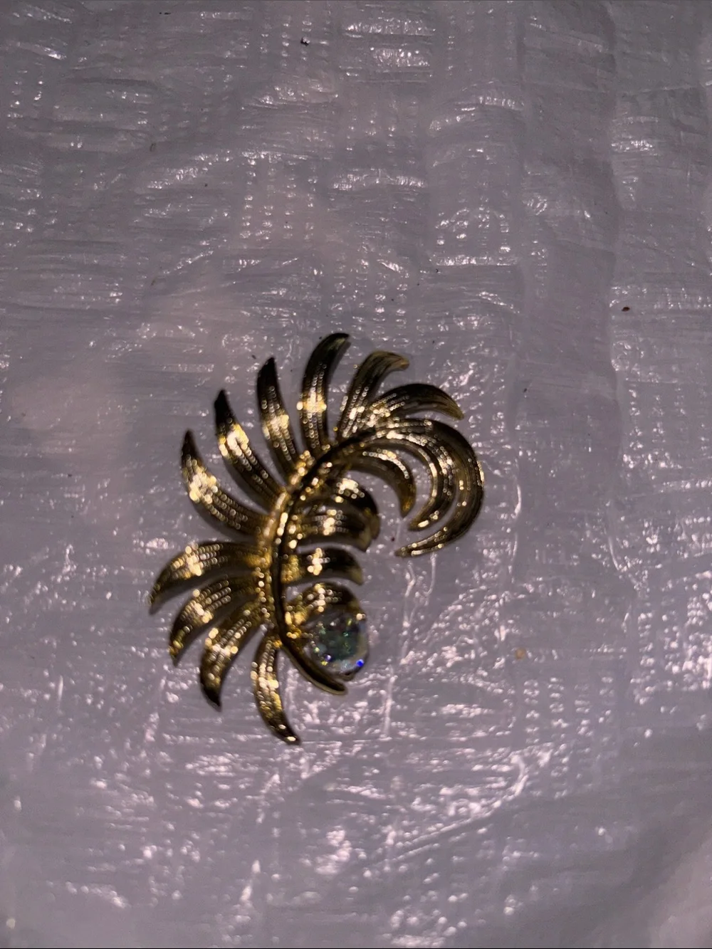 Gold Tone Floral Swirl Brooch with Iridescent Crystal
